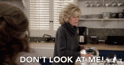 A Woman In A Kitchen Says " Don 'T Look At Me Netflix " GIF