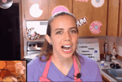A Woman In A Kitchen With Stickers On The Cabinets Including One That Says Gum GIF