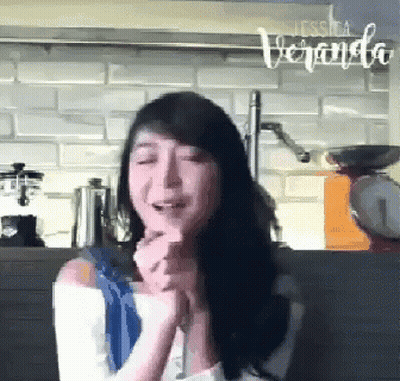 A Woman In A Kitchen With The Word Veranda On The Bottom GIF