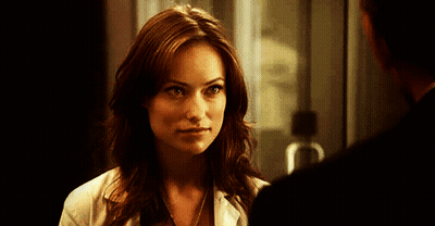 A Woman In A Lab Coat Is Looking At A Man GIF
