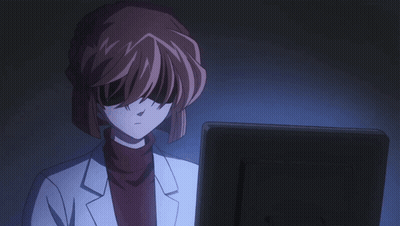 A Woman In A Lab Coat Is Looking At A Monitor GIF