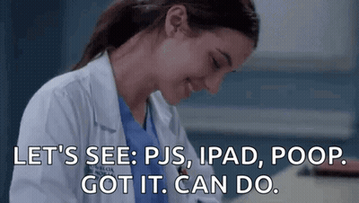 A Woman In A Lab Coat Is Sitting At A Desk With A Tablet And A Poop . GIF