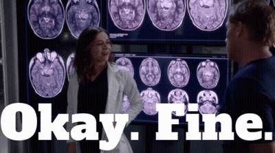 A Woman In A Lab Coat Is Standing In Front Of A Screen That Says Okay Fine GIF