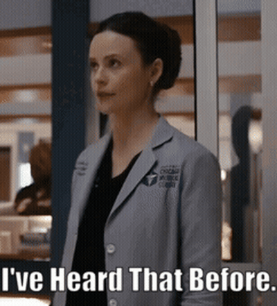 A Woman In A Lab Coat Is Standing In Front Of A Window And Says " I 'Ve Heard That Before " GIF