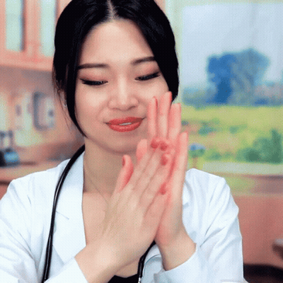 A Woman In A Lab Coat With A Stethoscope Around Her Neck Applauds GIF