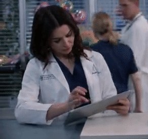 A Woman In A Lab Coat With The Letter A On Her Jacket GIF