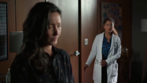 A Woman In A Lab Coat With The Number 21 On The Pocket GIF