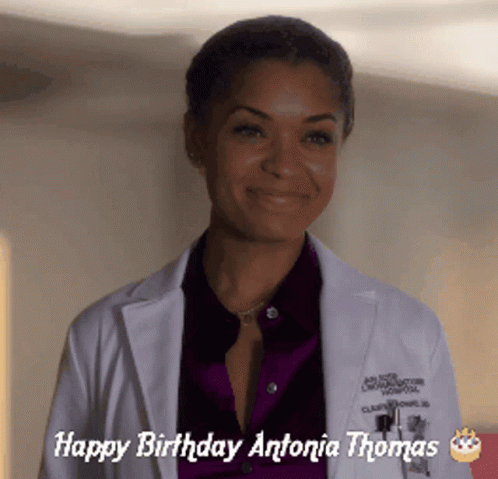 A Woman In A Lab Coat With The Words Happy Birthday Antonia Thomas GIF