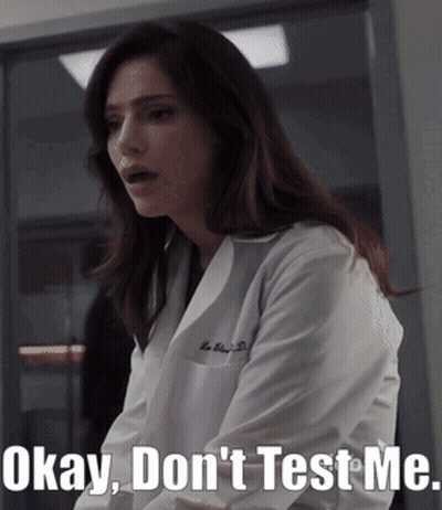 A Woman In A Lab Coat With The Words Okay Don 'T Test Me GIF