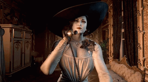 A Woman In A Large Hat Is Talking On A Phone In A Room . GIF