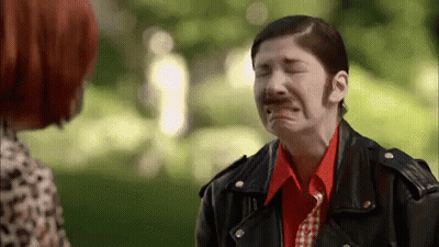 A Woman In A Leather Jacket Is Crying While Talking To Another Woman In A Park . GIF