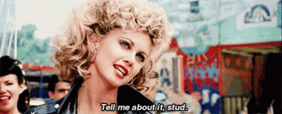 A Woman In A Leather Jacket Is Saying Tell Me About It Stud GIF