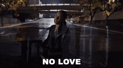 A Woman In A Leather Jacket Is Singing A Song With The Words No Love Behind Her GIF