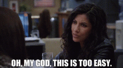 A Woman In A Leather Jacket Is Sitting At A Table With A Glass Of Water . GIF