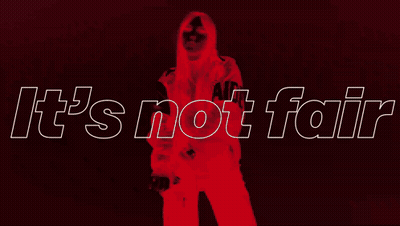 A Woman In A Leather Jacket Is Standing In Front Of A Sign That Says It 'S Not Fair GIF
