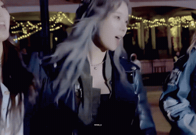 A Woman In A Leather Jacket Is Standing Next To Another Woman In A Blue Jacket GIF