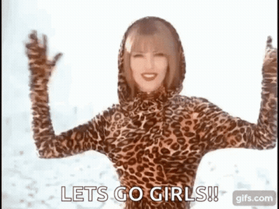 A Woman In A Leopard Print Bodysuit Is Dancing In The Snow . GIF