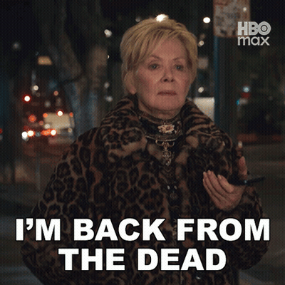 A Woman In A Leopard Print Coat Is Saying " I 'M Back From The Dead " GIF