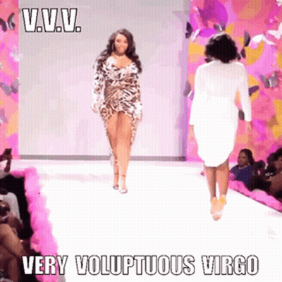 A Woman In A Leopard Print Dress Walks Down A Runway With The Caption " Very Voluptuous Virgo " GIF