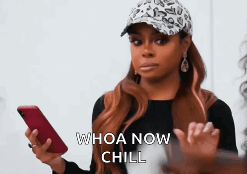 A Woman In A Leopard Print Hat Is Holding A Cell Phone And Says Whoa Now Chill GIF