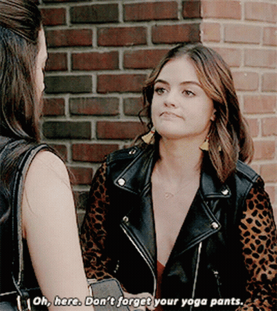 A Woman In A Leopard Print Jacket Is Talking To Another Woman In Front Of A Brick Wall GIF