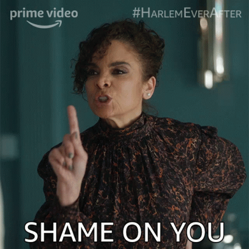 A Woman In A Leopard Print Top Is Pointing Her Finger At Someone And Says " Shame On You " GIF