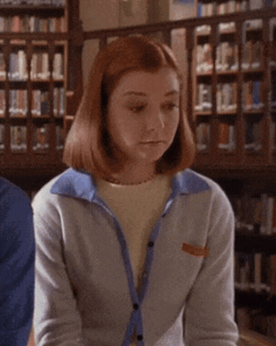 A Woman In A Library With The Words A-Ha Written On Her Face GIF