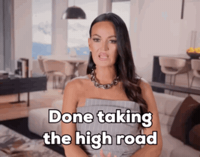A Woman In A Living Room With The Words Done Taking The High Road Above Her GIF