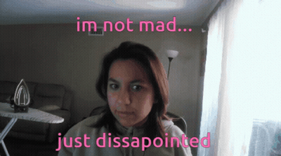 A Woman In A Living Room With The Words Im Not Mad Just Disappointed Above Her GIF