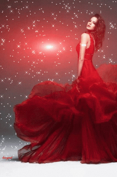 A Woman In A Long Red Dress Is Standing In Front Of A Red Background GIF