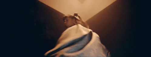 A Woman In A Long White Dress Is Dancing GIF