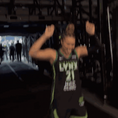 A Woman In A Lynx Jersey Is Dancing In A Tunnel GIF