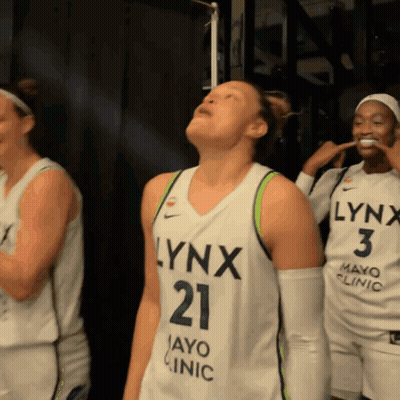 A Woman In A Lynx Jersey Looks Up GIF
