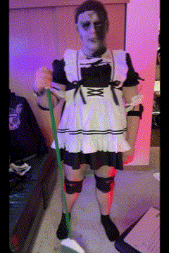 A Woman In A Maid Costume Is Holding A Mop GIF