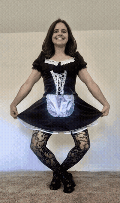 A Woman In A Maid Costume Is Smiling GIF