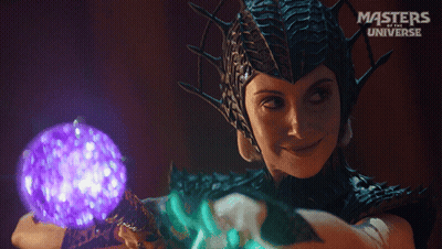 A Woman In A Masters Of The Universe Costume Holding A Purple Ball GIF