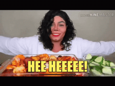 A Woman In A Michael Jackson Costume Is Eating A Casserole Dish Of Food With The Words Hee Heeeee On It GIF