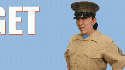 A Woman In A Military Uniform Stands In Front Of The Words Get To Work GIF