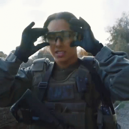 A Woman In A Military Uniform With The Word N.w.t. On Her Chest GIF