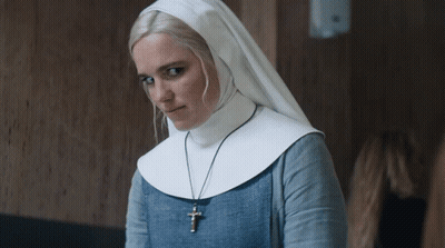 A Woman In A Nun 'S Outfit Has A Cross Necklace GIF