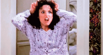 A Woman In A Pajama Shirt Is Holding Her Hair In Her Hands And Screaming . GIF
