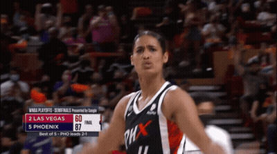 A Woman In A Phoenix Jersey Stands In Front Of A Crowd During A Game GIF