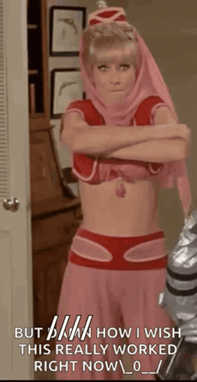 A Woman In A Pink And Red Costume With Her Arms Crossed Is Standing In A Room With A Door . GIF