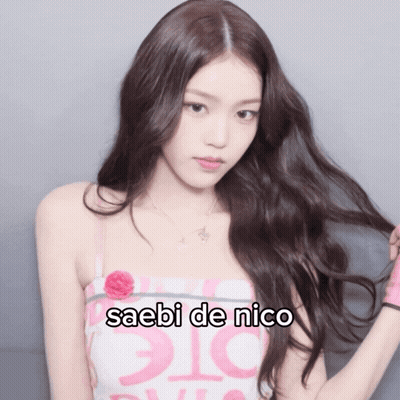A Woman In A Pink And White Dress With The Words Saebi De Nico On The Bottom GIF