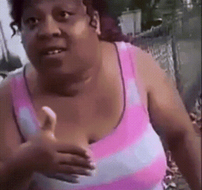 A Woman In A Pink And White Striped Tank Top Is Giving A Thumbs Up GIF