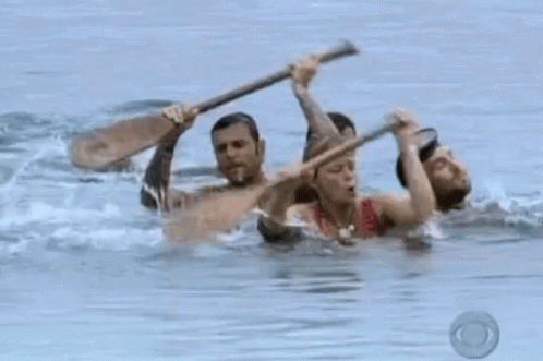 A Woman In A Pink Bikini Is Holding A Wooden Stick In A Pool Of Water . GIF