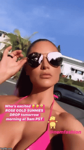 A Woman In A Pink Bikini Is Wearing Sunglasses And A Caption That Says Who 'S Excited GIF