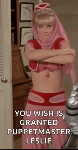 A Woman In A Pink Costume Is Standing In Front Of A Door With Her Arms Crossed And A Quote . GIF