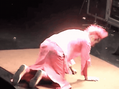 A Woman In A Pink Dress Crawls On The Floor GIF