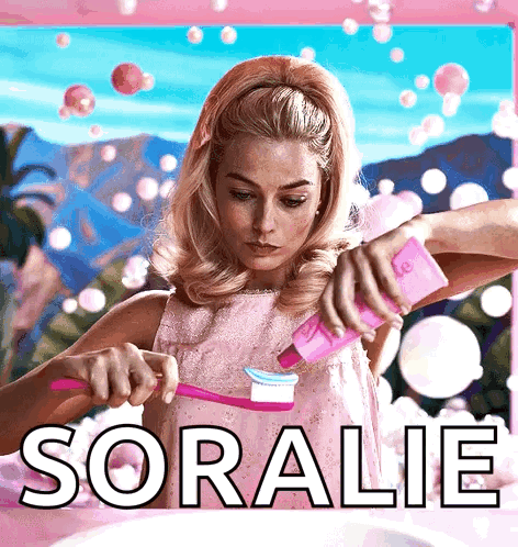 A Woman In A Pink Dress Is Brushing Her Teeth And The Name Soralie Is On The Bottom Right GIF